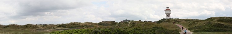 Blick über die Dünenlandschaft auf Langeoog in Richtung Ortsmitte